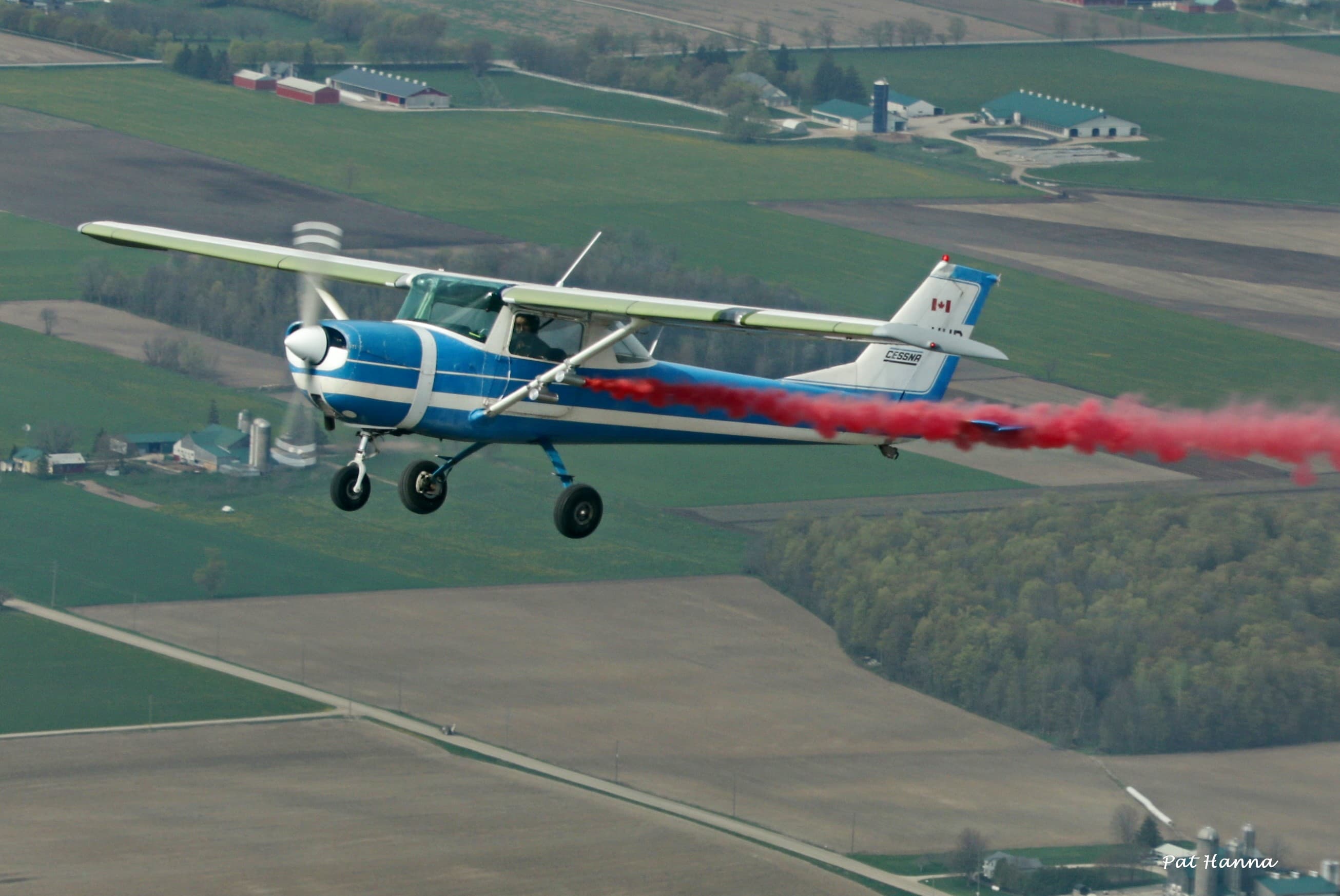 Cessna with red smoke display